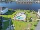 Aerial view of the pool and hot tub area that is located on the waterway with mature landscaping and manicured lawns at 1505 Lantern Rest Dr. # 301, Myrtle Beach, SC 29579