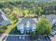 Aerial view of the property including parking lot, community golf course and surrounding foliage at 1505 Lantern Rest Dr. # 301, Myrtle Beach, SC 29579