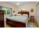 Cozy bedroom featuring a bed, nightstand, and a window with views of the surrounding landscape at 1505 Lantern Rest Dr. # 301, Myrtle Beach, SC 29579