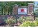 The Villages of Arrowhead sign is surrounded by flowering plants at 1505 Lantern Rest Dr. # 301, Myrtle Beach, SC 29579