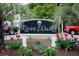 Riverwalk sign surrounded by flowers and plants at 1505 Lantern Rest Dr. # 301, Myrtle Beach, SC 29579