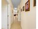 Long hallway featuring beige walls, tile flooring, and framed portraits at 1505 Lantern Rest Dr. # 301, Myrtle Beach, SC 29579