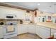 Bright kitchen with white cabinets, standard appliances, and light countertops at 1505 Lantern Rest Dr. # 301, Myrtle Beach, SC 29579
