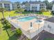 Inviting outdoor pool and hot tub area surrounded by white fencing and lush landscaping at waterfront condos at 1505 Lantern Rest Dr. # 301, Myrtle Beach, SC 29579