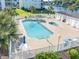 Community pool and hot tub are located steps from the waterway and surrounded by palm trees at 1505 Lantern Rest Dr. # 301, Myrtle Beach, SC 29579