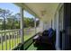 Screened-in porch with ceiling fan, outdoor furniture, and views of the green golf course at 1505 Lantern Rest Dr. # 301, Myrtle Beach, SC 29579