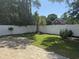 A view of the fenced-in backyard featuring a brick patio and well-maintained lawn at 152 Rose Water Loop, Myrtle Beach, SC 29588