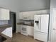 The kitchen boasts white appliances, granite countertops, and ample cabinet space at 152 Rose Water Loop, Myrtle Beach, SC 29588