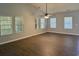 Bright living room featuring wood floors, large windows, and a modern ceiling fan at 152 Rose Water Loop, Myrtle Beach, SC 29588