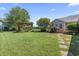 Expansive backyard showcasing a pergola with swing set, lush lawn, and pathway to the home's deck at 1609 Bridgebrook Ln., Conway, SC 29527
