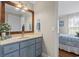 Bathroom featuring a blue vanity, light countertop, and a mirror with a wood frame at 1609 Bridgebrook Ln., Conway, SC 29527