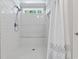 Bright bathroom featuring a tiled shower, rain shower head, and a window for natural light at 1609 Bridgebrook Ln., Conway, SC 29527