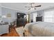 Spacious bedroom features hardwood floors, a ceiling fan, and a king bed with lots of natural light at 1609 Bridgebrook Ln., Conway, SC 29527