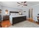 Comfortable bedroom featuring hardwood floors, a ceiling fan, and a king bed with a fluffy rug at 1609 Bridgebrook Ln., Conway, SC 29527