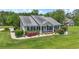 Beautiful home exterior with landscaped yard and garden beds plus a welcoming front porch at 1609 Bridgebrook Ln., Conway, SC 29527