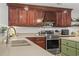 Close-up of kitchen with stainless steel oven and sink, along with wooden cabinets and countertop at 1609 Bridgebrook Ln., Conway, SC 29527