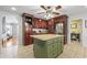 Spacious kitchen with an island, dark wood cabinets, stainless steel appliances, and tiled flooring at 1609 Bridgebrook Ln., Conway, SC 29527