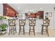 Kitchen featuring bar stool seating, dark wood cabinetry, and modern appliances in a neutral color palette at 1609 Bridgebrook Ln., Conway, SC 29527