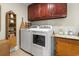Efficient laundry room equipped with a washer, dryer, and cabinet storage at 1609 Bridgebrook Ln., Conway, SC 29527