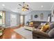 Comfortable living area showcasing hardwood floors, a plush sofa, and abundant natural light at 1609 Bridgebrook Ln., Conway, SC 29527