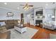 Cozy living room featuring hardwood floors, neutral color scheme, and fireplace at 1609 Bridgebrook Ln., Conway, SC 29527