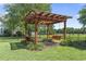 Backyard pergola featuring a swing and seating area perfect for enjoying the outdoors within a fenced yard at 1609 Bridgebrook Ln., Conway, SC 29527