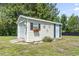 Exterior view of a shed with roll-up door, window box, and decorative butterfly accents at 1609 Bridgebrook Ln., Conway, SC 29527