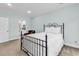 Charming bedroom featuring an iron bed frame, neutral carpet, and a glimpse into the ensuite bath at 179 Golden Bear Dr. # C4, Pawleys Island, SC 29585