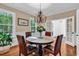 Bright dining room featuring a chandelier, hardwood floors and a table with seating for four at 179 Golden Bear Dr. # C4, Pawleys Island, SC 29585