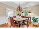 Dining room featuring a chandelier, hardwood floors and a table with seating for four at 179 Golden Bear Dr. # C4, Pawleys Island, SC 29585