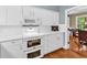 Bright kitchen features white cabinetry, stainless steel appliances, and hardwood flooring at 179 Golden Bear Dr. # C4, Pawleys Island, SC 29585