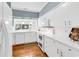 Bright, updated kitchen with white appliances, countertops, and cabinets, featuring hardwood floors at 179 Golden Bear Dr. # C4, Pawleys Island, SC 29585
