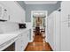 Kitchen featuring white cabinets, countertops, and hardwood floors with a dining room view at 179 Golden Bear Dr. # C4, Pawleys Island, SC 29585