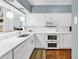Clean, white kitchen featuring modern appliances, new backsplash, and hardwood flooring at 179 Golden Bear Dr. # C4, Pawleys Island, SC 29585