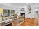Bright living room featuring hardwood floors, a cozy fireplace, and custom built-in shelving at 179 Golden Bear Dr. # C4, Pawleys Island, SC 29585