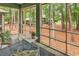Relaxing screened-in porch with lush backyard views, seating area and natural light at 179 Golden Bear Dr. # C4, Pawleys Island, SC 29585