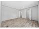 Bedroom featuring wood-look floors, neutral walls, and ample closet space at 1962 Pint Circle, Longs, SC 29568