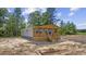 New home with front porch, wood trim, yard, surrounded by a lush green landscape at 1962 Pint Circle, Longs, SC 29568