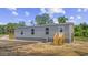 This home has stone accents, a wooden porch, and stairs, and a partial driveway at 1962 Pint Circle, Longs, SC 29568
