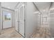 Hallway featuring an exterior door and louvered doors and wood-look flooring at 1962 Pint Circle, Longs, SC 29568