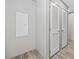 Hallway featuring louvered doors and wood-look flooring at 1962 Pint Circle, Longs, SC 29568