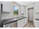 Kitchen featuring a stainless steel sink with a view and a door to a pantry with metal shelving at 1962 Pint Circle, Longs, SC 29568
