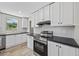 Kitchen features stainless steel appliances, white cabinetry, and wood-look flooring at 1962 Pint Circle, Longs, SC 29568