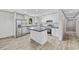 A modern kitchen featuring an island, stainless steel appliances, and white cabinets at 1962 Pint Circle, Longs, SC 29568