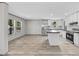 Kitchen, dining and living room area, features a kitchen island and wood-look flooring at 1962 Pint Circle, Longs, SC 29568