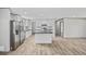 A kitchen featuring white cabinets, black countertops, stainless steel appliances, and an island at 1962 Pint Circle, Longs, SC 29568