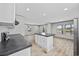 Bright kitchen featuring an island with a dark countertop and white cabinets with modern stainless steel appliances at 1962 Pint Circle, Longs, SC 29568