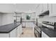Kitchen featuring stainless steel appliances, white cabinetry, island and wood-look flooring at 1962 Pint Circle, Longs, SC 29568