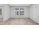 Bright, airy living room with wood-look flooring and views of the surrounding landscape at 1962 Pint Circle, Longs, SC 29568