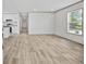A view of the open floor plan leading from the living area to the kitchen with white cabinetry at 1962 Pint Circle, Longs, SC 29568